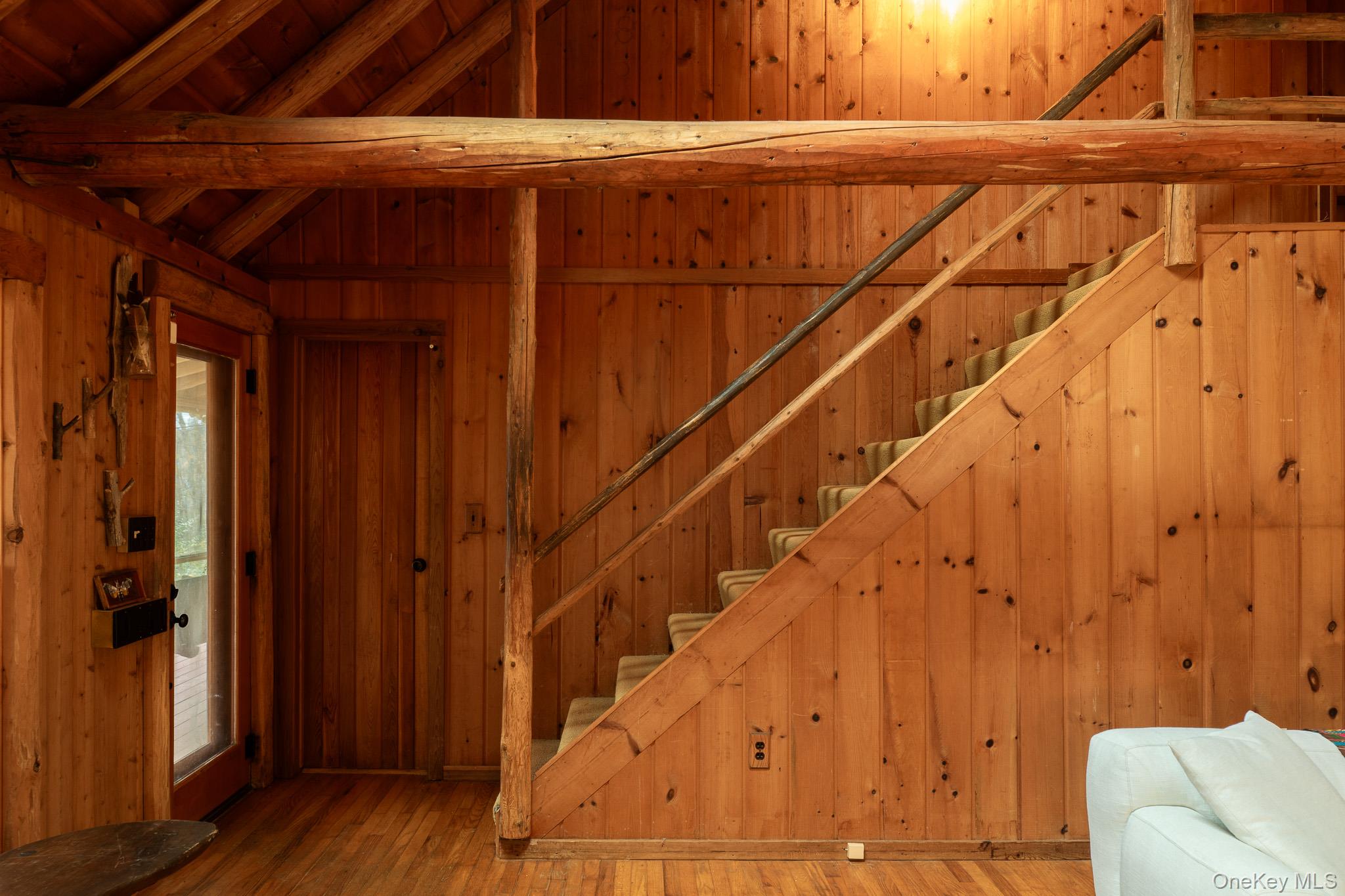 79 Torre Rock Road Red Hook, NY 12571 - Photo 12 of 33 Staircase with wooden walls and wood-type flooring