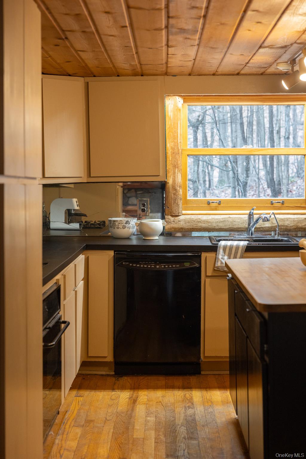 79 Torre Rock Road Red Hook, NY 12571 - Photo 19 of 33 Kitchen featuring wooden ceiling, black appliances, dark countertops, and light wood-style flooring