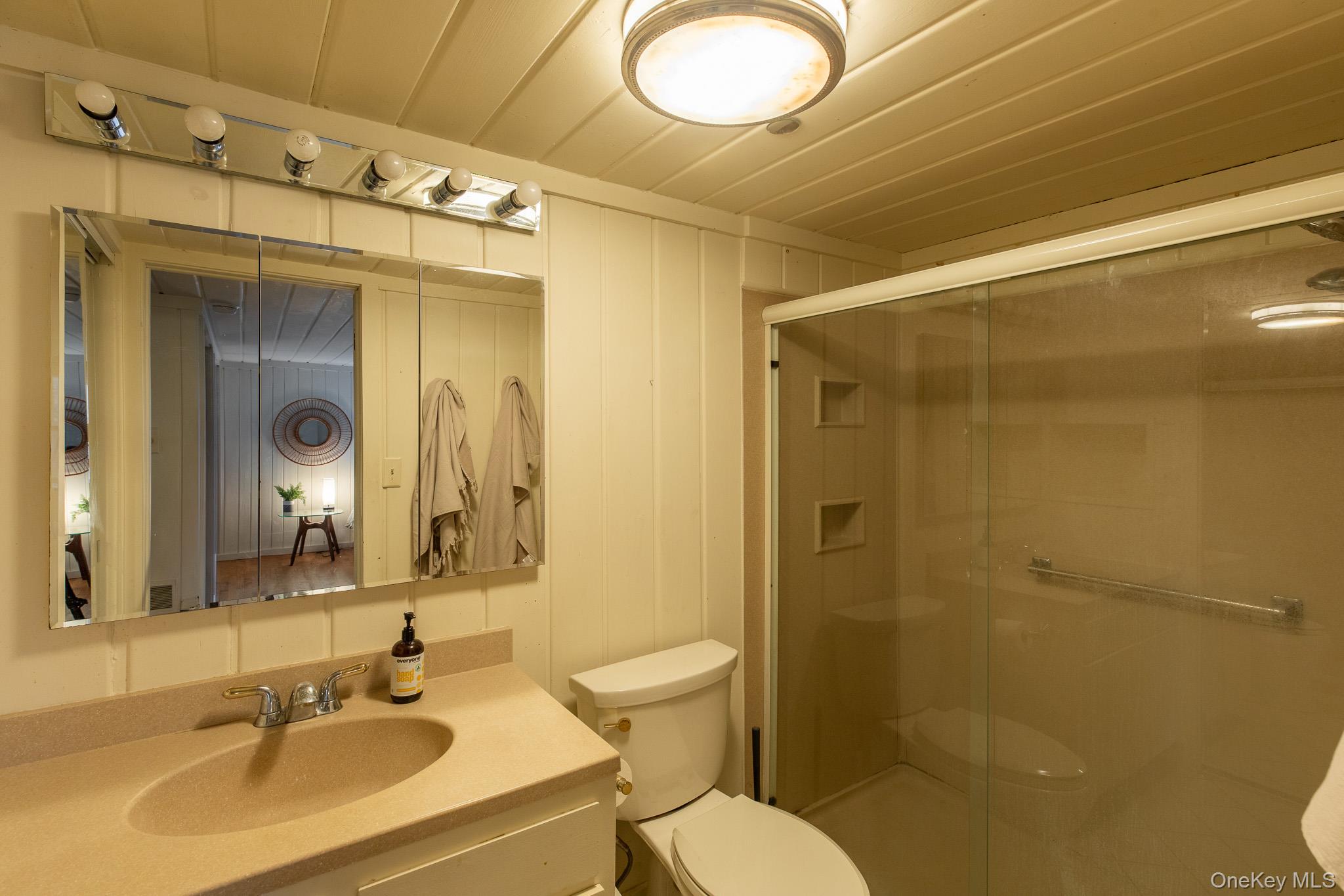 79 Torre Rock Road Red Hook, NY 12571 - Photo 22 of 33 Bathroom featuring a shower stall, vanity, a decorative wall, and wooden ceiling