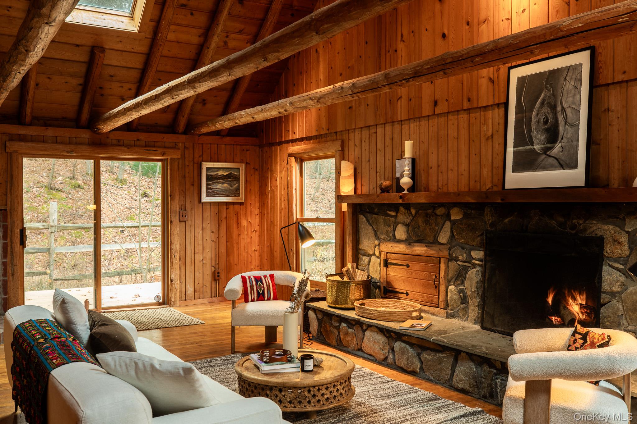 79 Torre Rock Road Red Hook, NY 12571 - Photo 7 of 33 Living area featuring a fireplace, wood finished floors, wood walls, a wood ceiling with exposed beams, and high vaulted ceiling