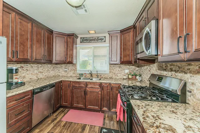 a kitchen with a sink stove and cabinets
