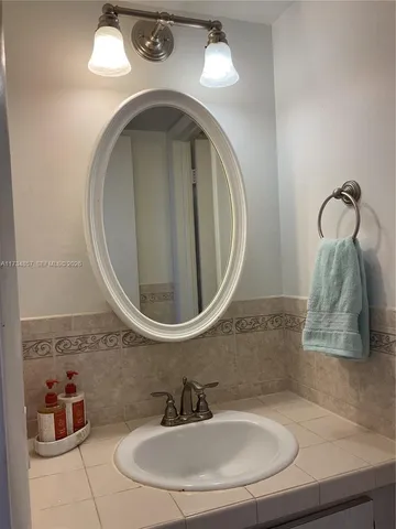 a green field with some trees in the background