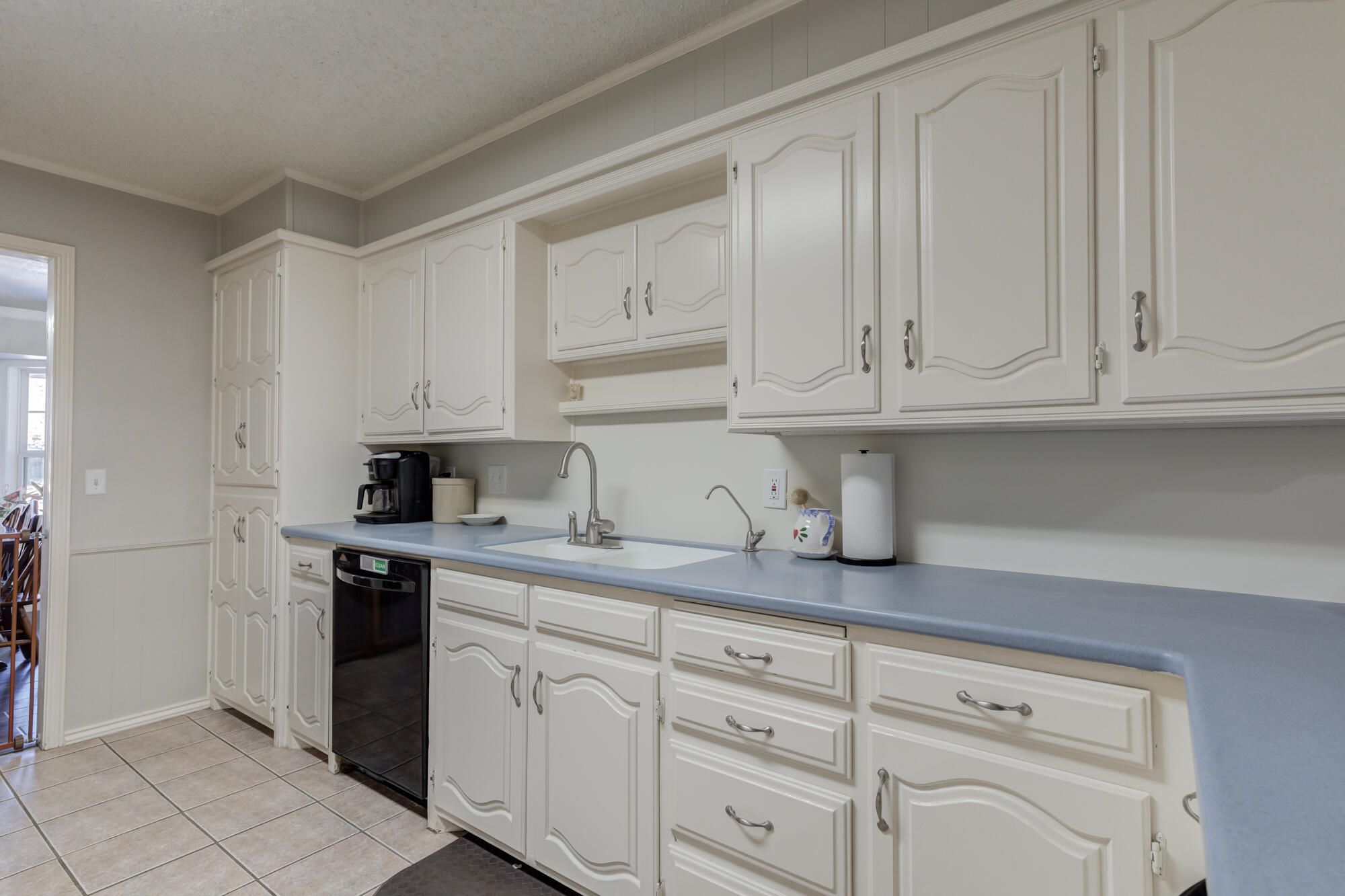 4809 78th Street Lubbock, TX 79424 - Photo 14 of 48 a kitchen with granite countertop white cabinets and white appliances