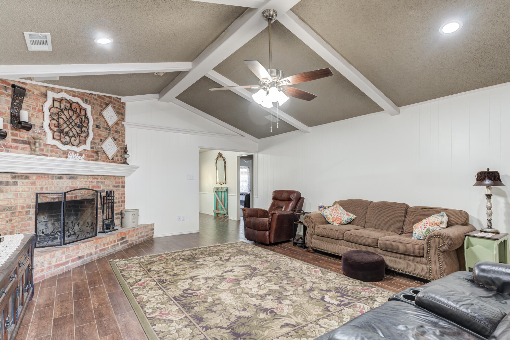 4809 78th Street Lubbock, TX 79424 - Photo 18 of 48 a living room with furniture and a fireplace