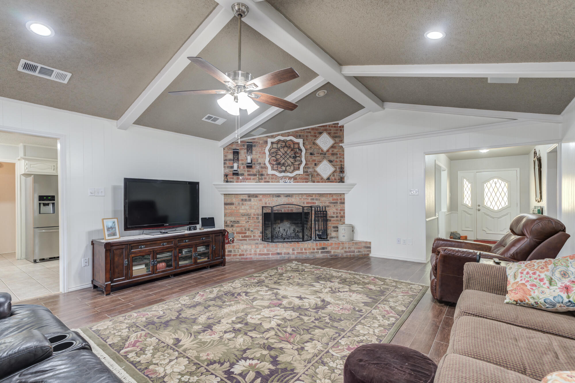 4809 78th Street Lubbock, TX 79424 - Photo 19 of 48 a living room with furniture and a flat screen tv