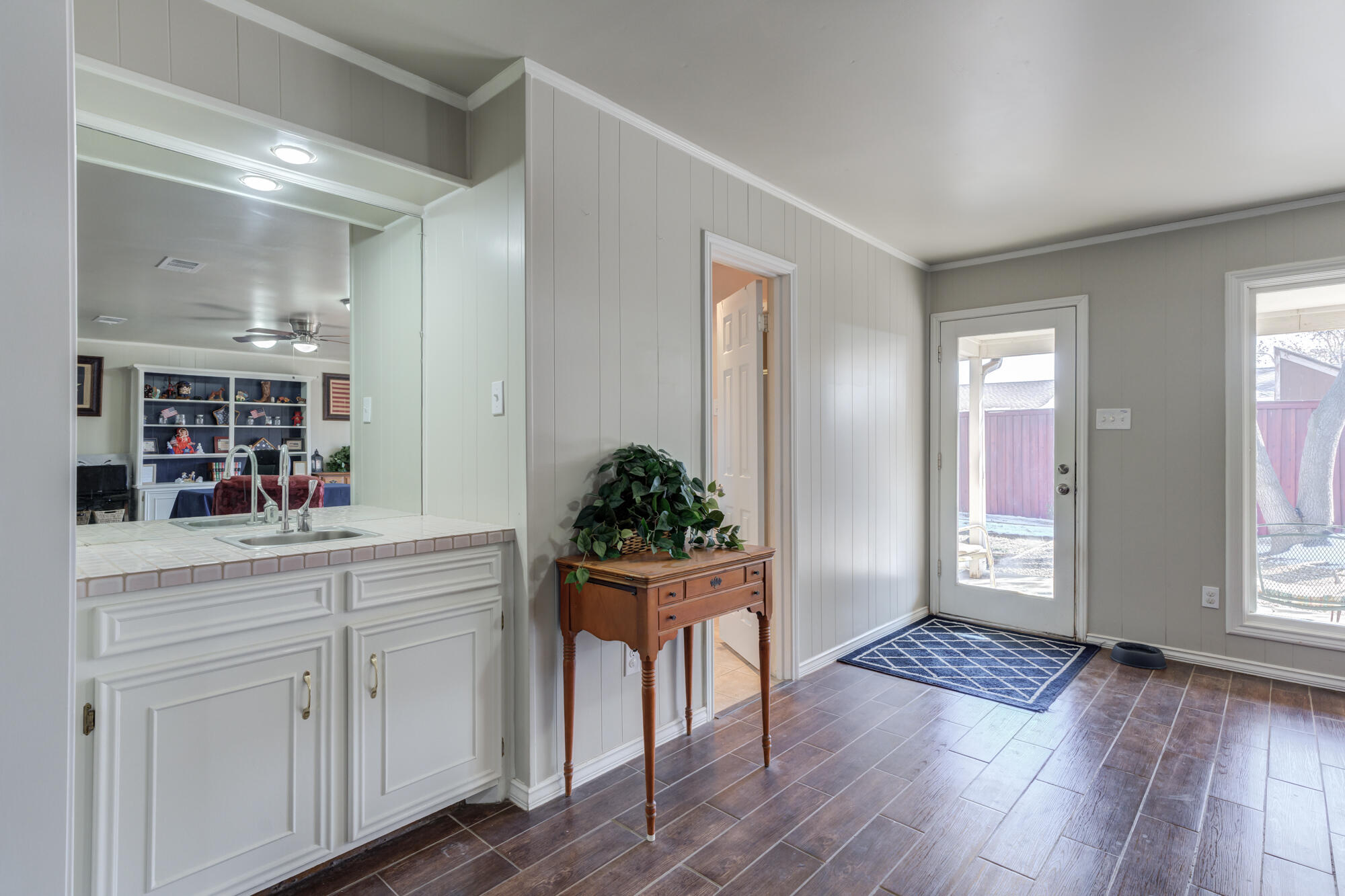 4809 78th Street Lubbock, TX 79424 - Photo 22 of 48 a kitchen with white cabinets and wooden floor