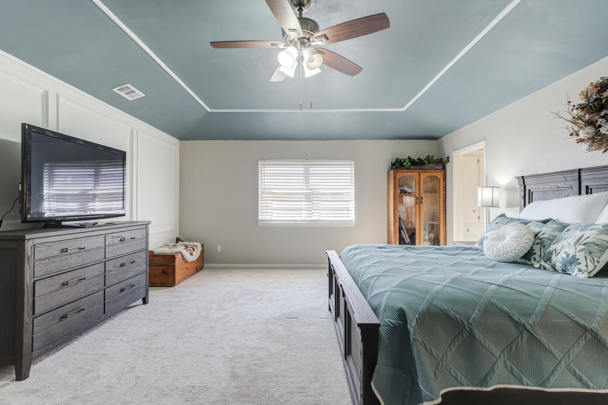 4809 78th Street Lubbock, TX 79424 - Photo 26 of 48 a bedroom with a bed and a flat screen tv