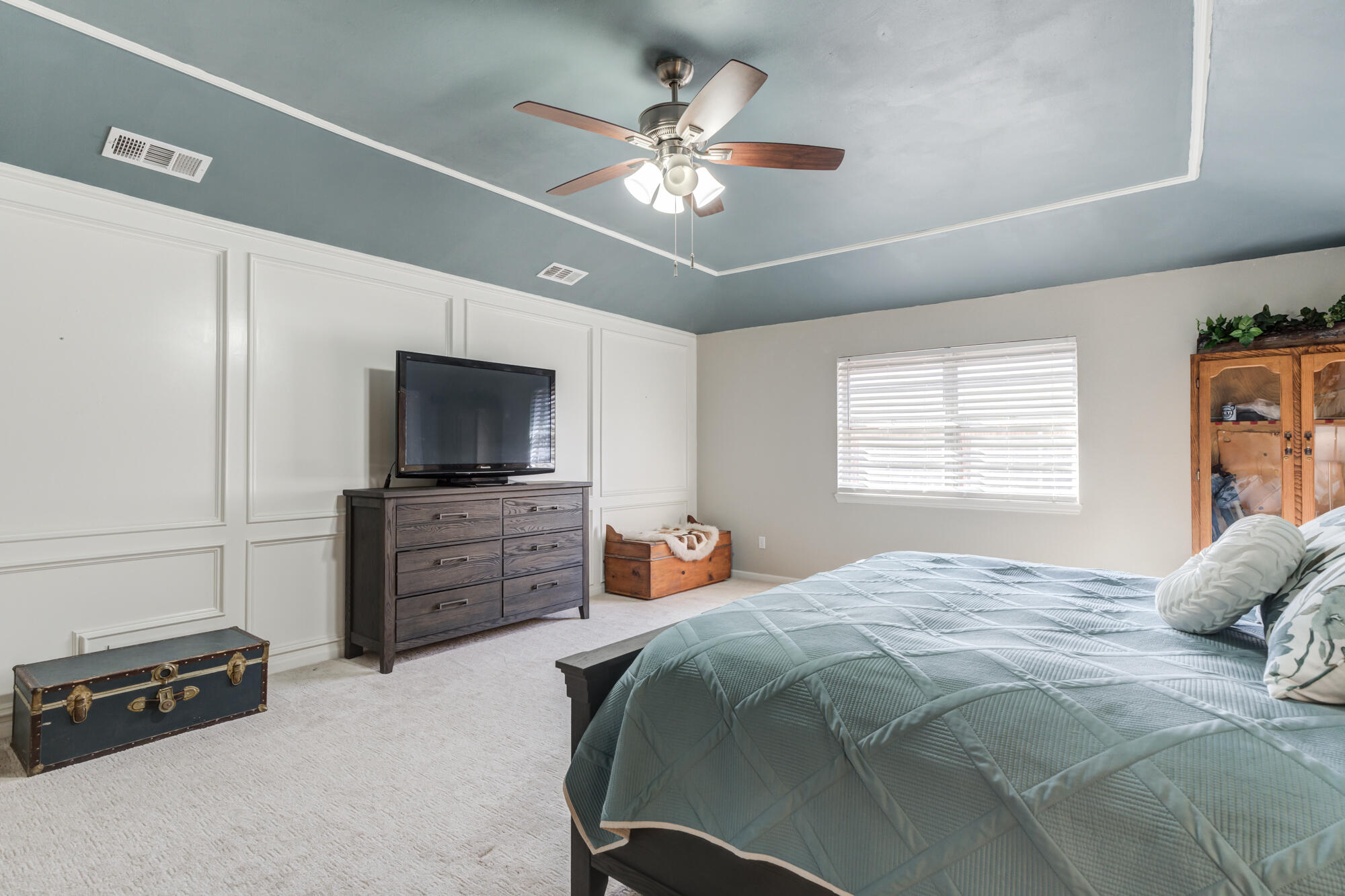 4809 78th Street Lubbock, TX 79424 - Photo 28 of 48 a bedroom with a bed and a flat screen tv