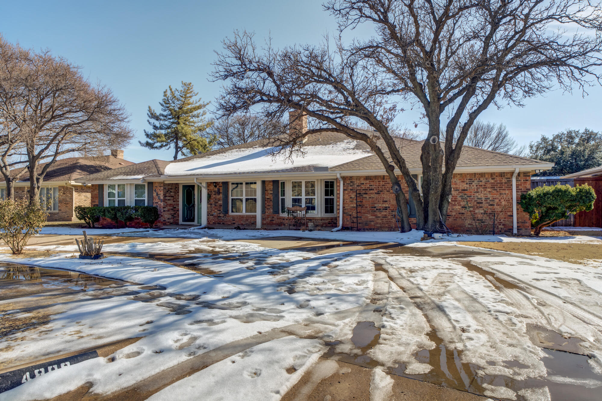 4809 78th Street Lubbock, TX 79424 - Photo 3 of 48 a front view of a house with a yard