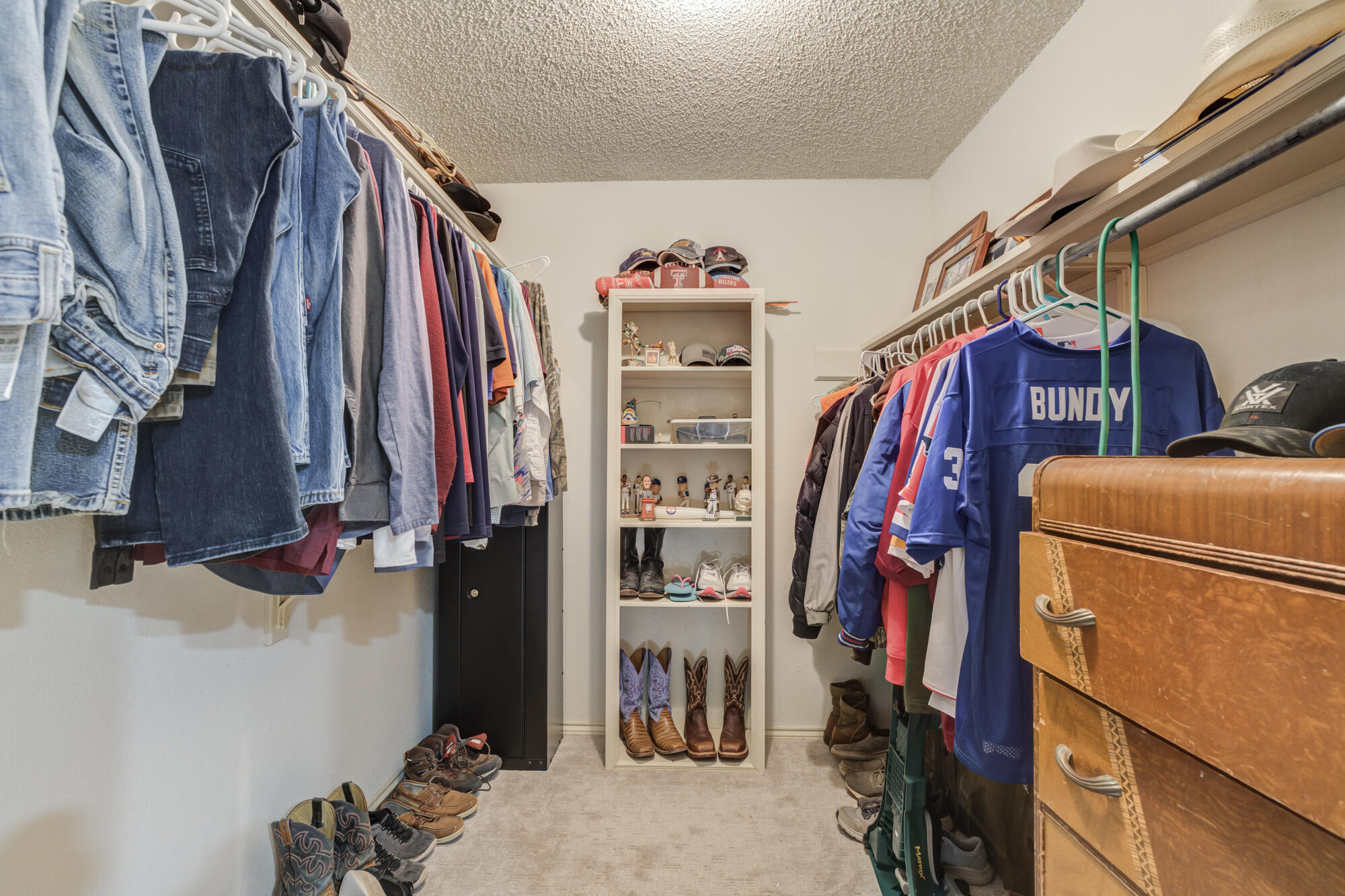 4809 78th Street Lubbock, TX 79424 - Photo 32 of 48 a view of walk in closet with clothes and shoes