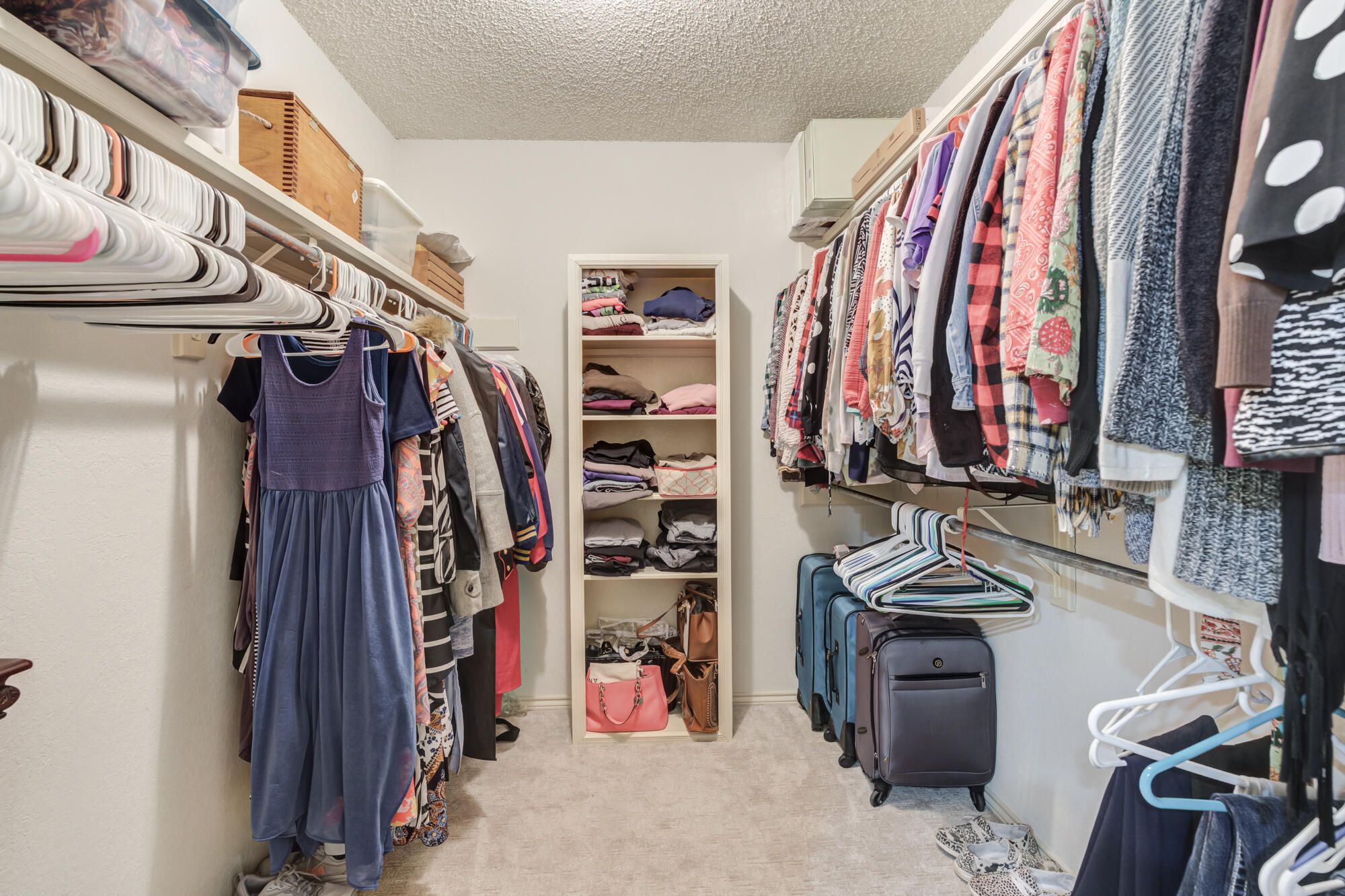 4809 78th Street Lubbock, TX 79424 - Photo 33 of 48 a view of walk in closet with clothes and shoes