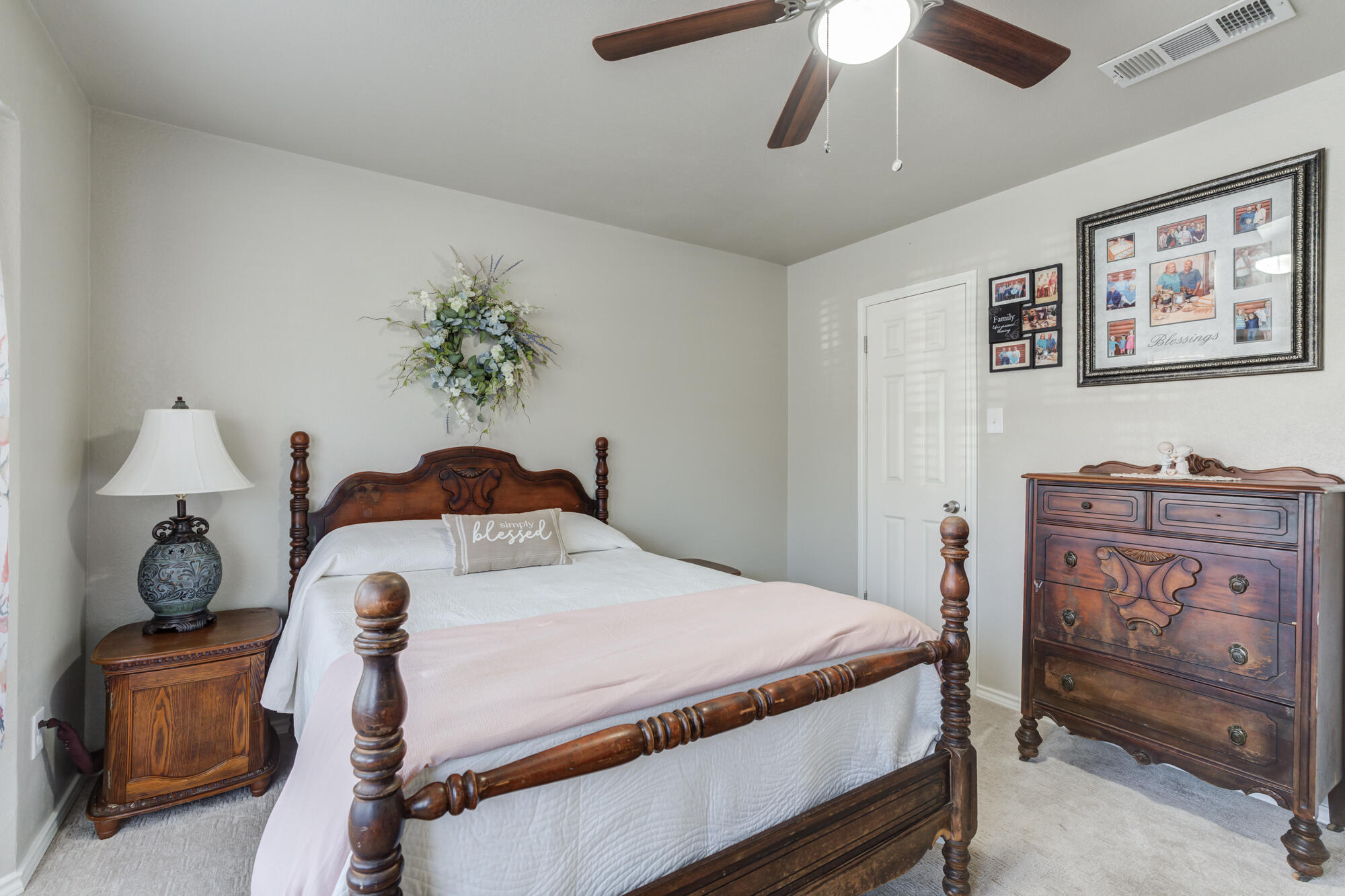 4809 78th Street Lubbock, TX 79424 - Photo 34 of 48 a bedroom with a bed and a chandelier