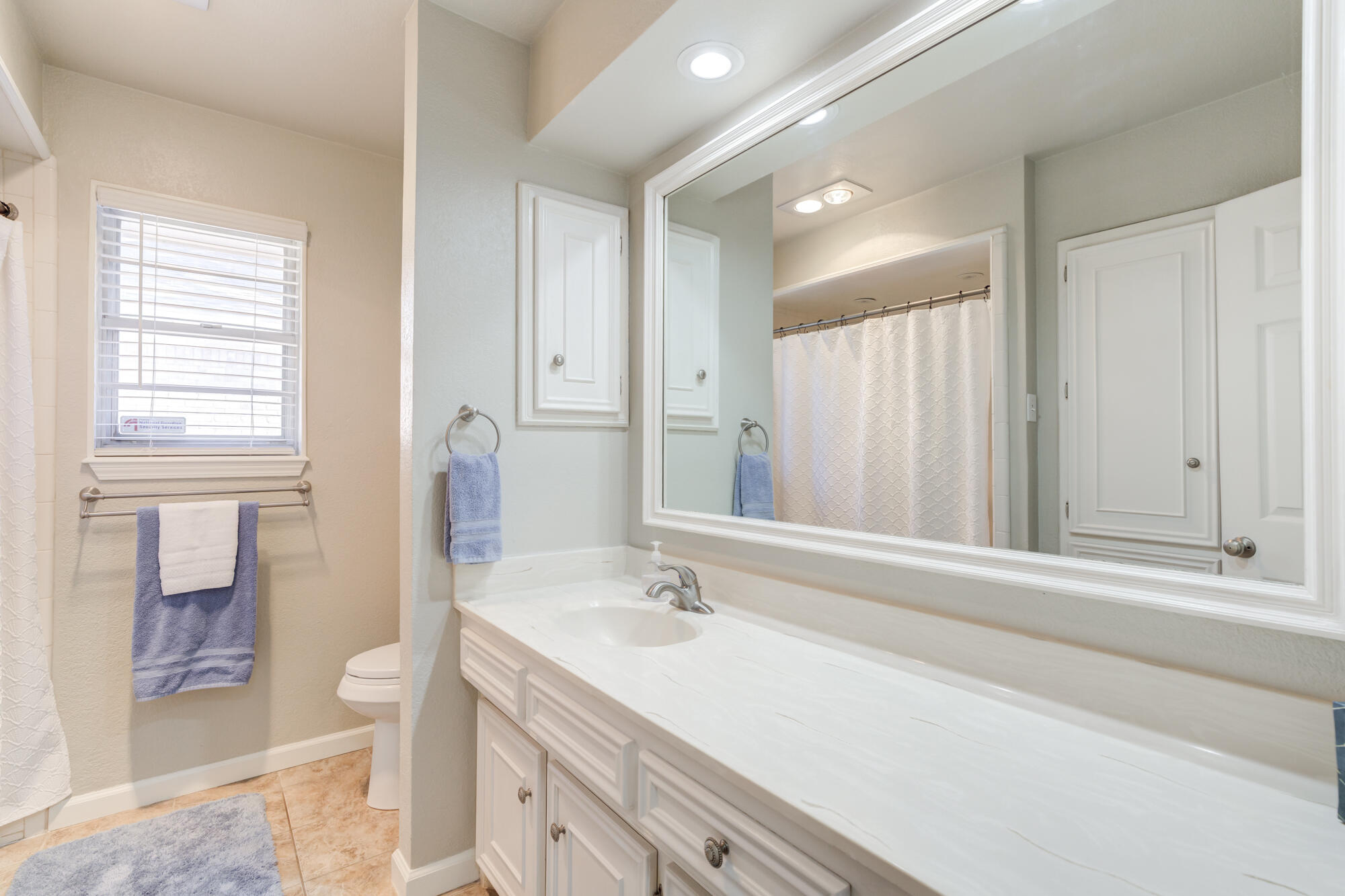 4809 78th Street Lubbock, TX 79424 - Photo 36 of 48 a bathroom with a granite countertop sink and a mirror
