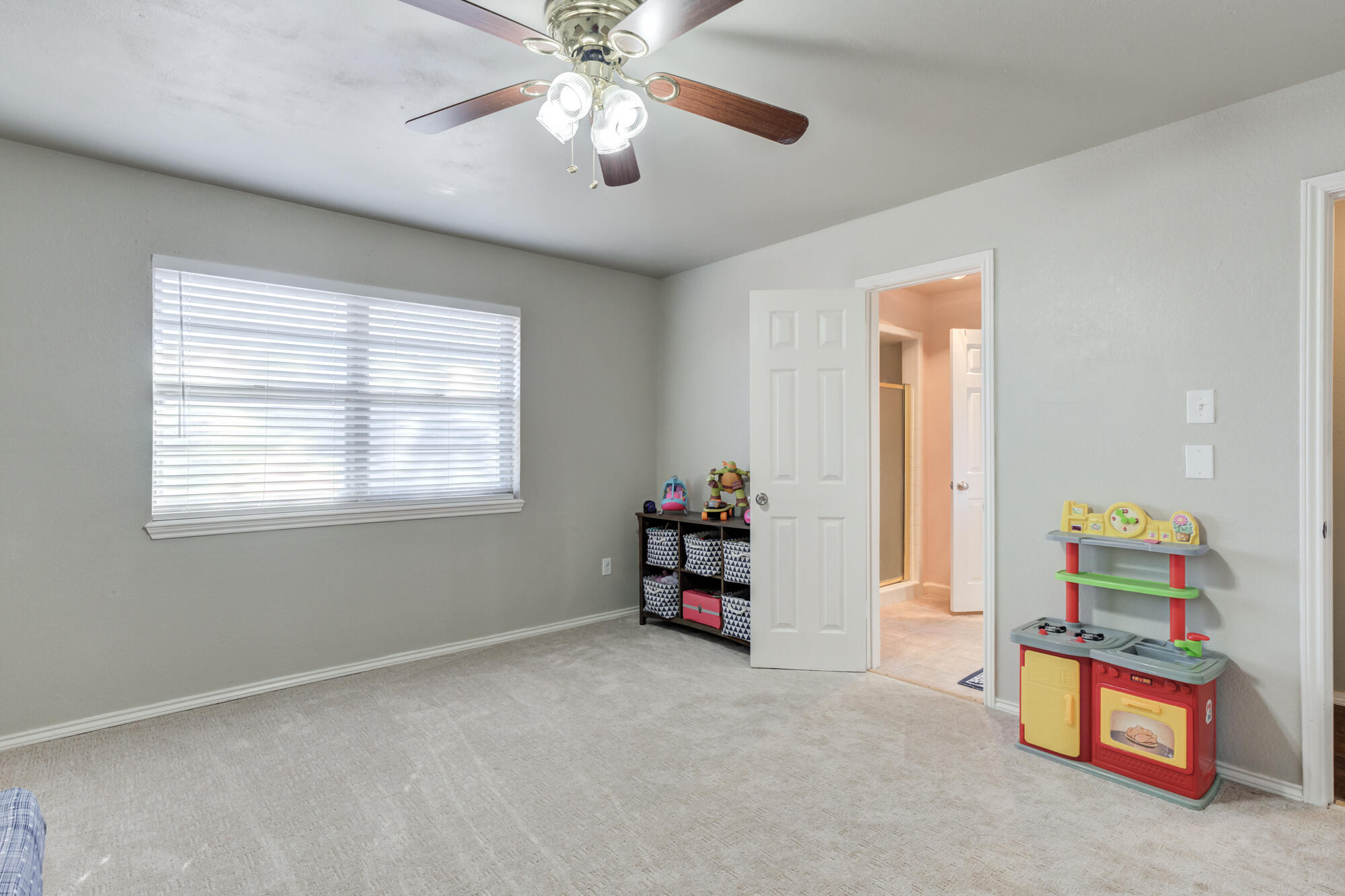 4809 78th Street Lubbock, TX 79424 - Photo 41 of 48 an empty room with toys and chandelier fan