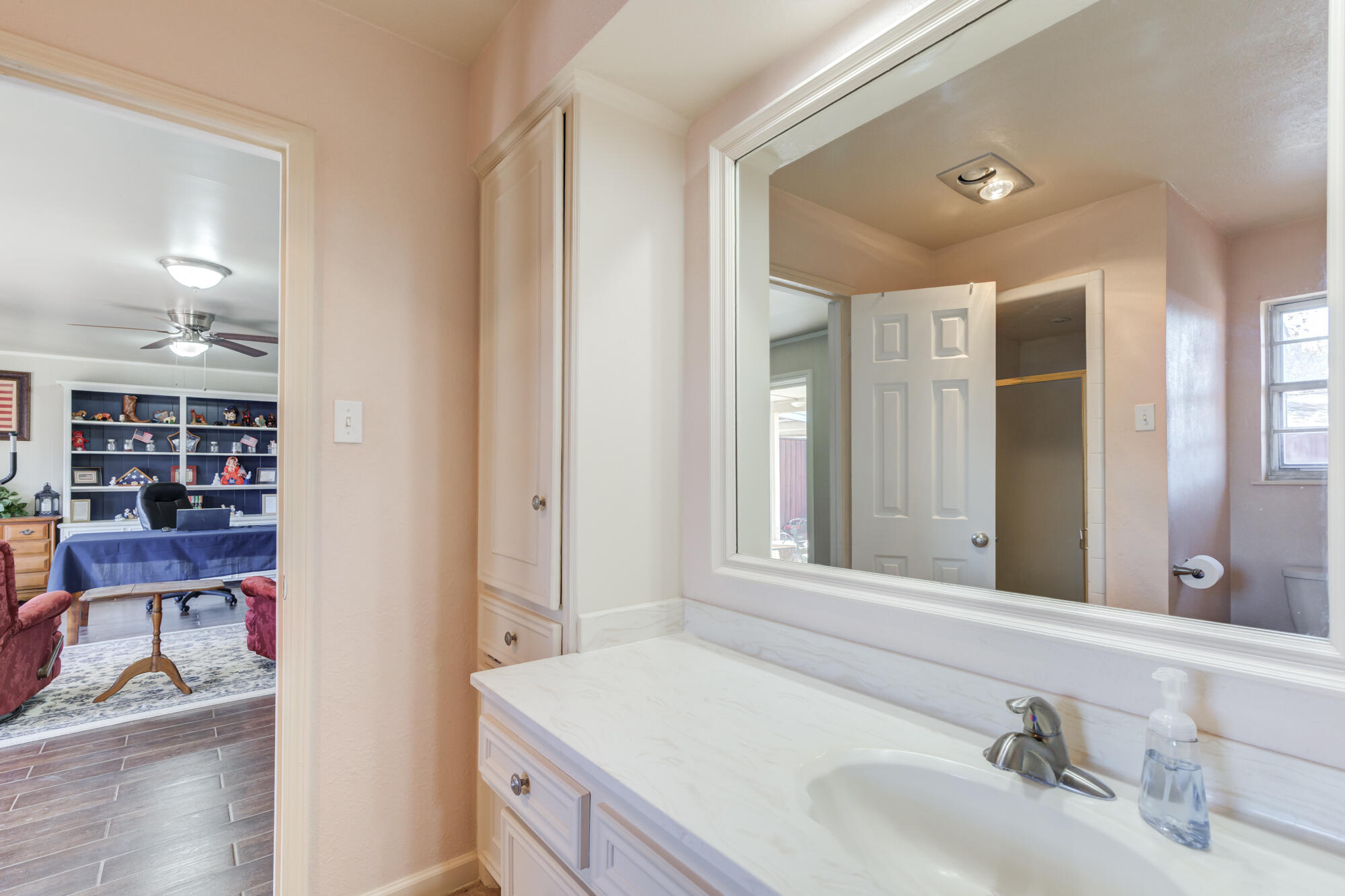4809 78th Street Lubbock, TX 79424 - Photo 43 of 48 a bathroom with a sink and a mirror