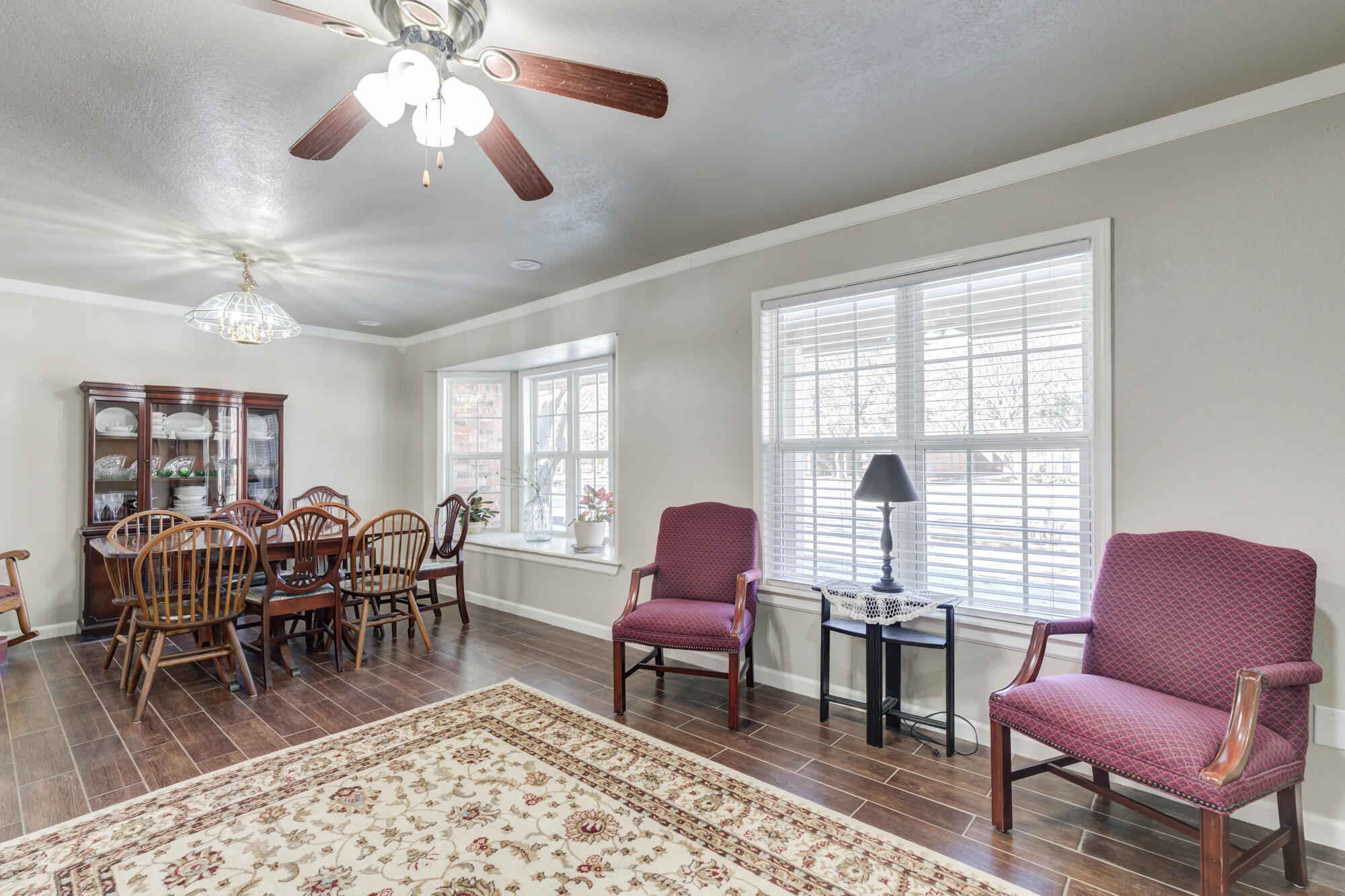 4809 78th Street Lubbock, TX 79424 - Photo 7 of 48 a living room with furniture a rug and a floor to ceiling window