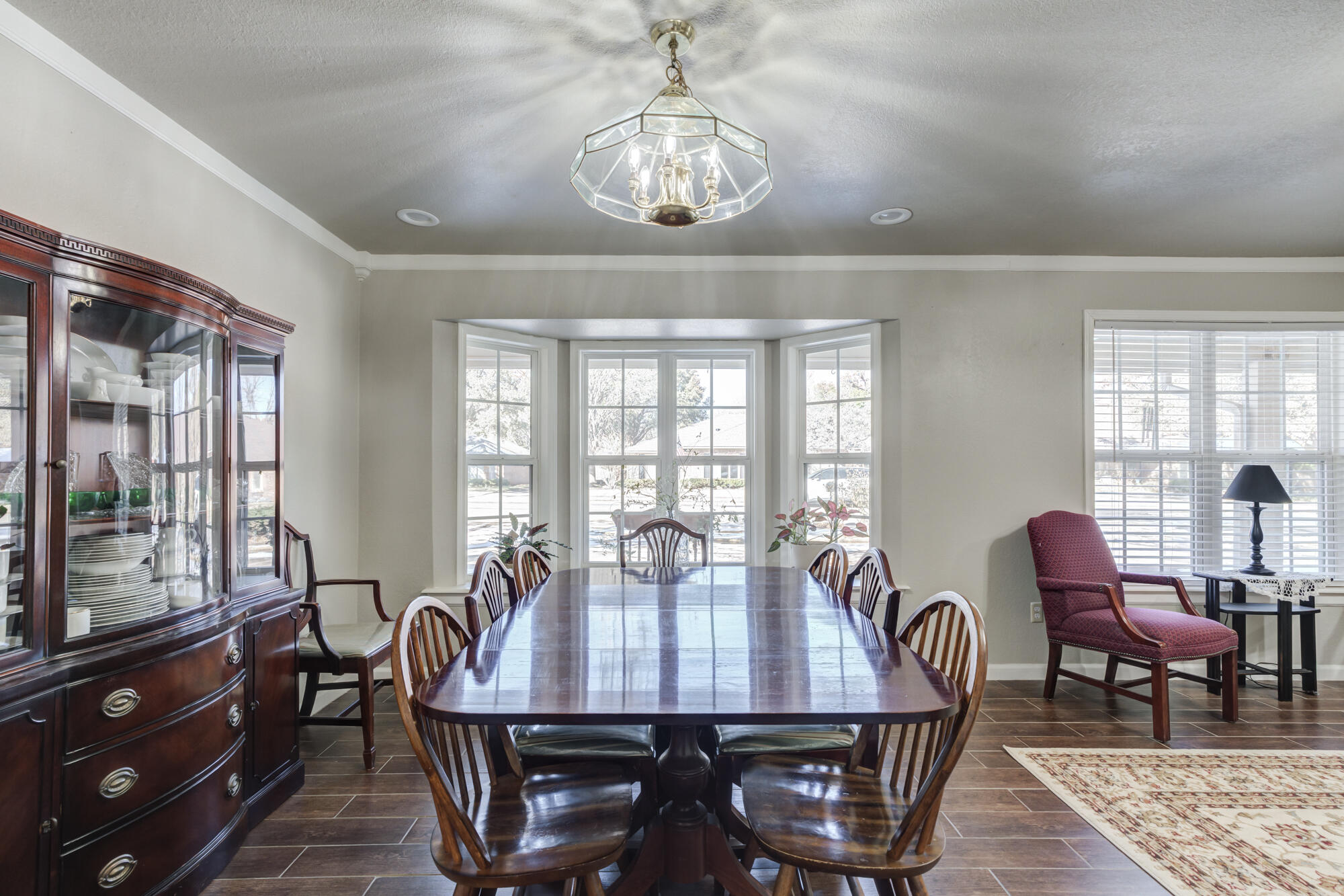 4809 78th Street Lubbock, TX 79424 - Photo 10 of 48 a view of a dining room with furniture a chandelier and wooden floor