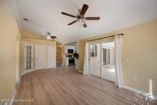 a view of a kitchen with a sink and a stove top oven