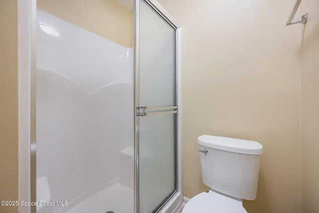 a white toilet sitting next to a bathroom sink