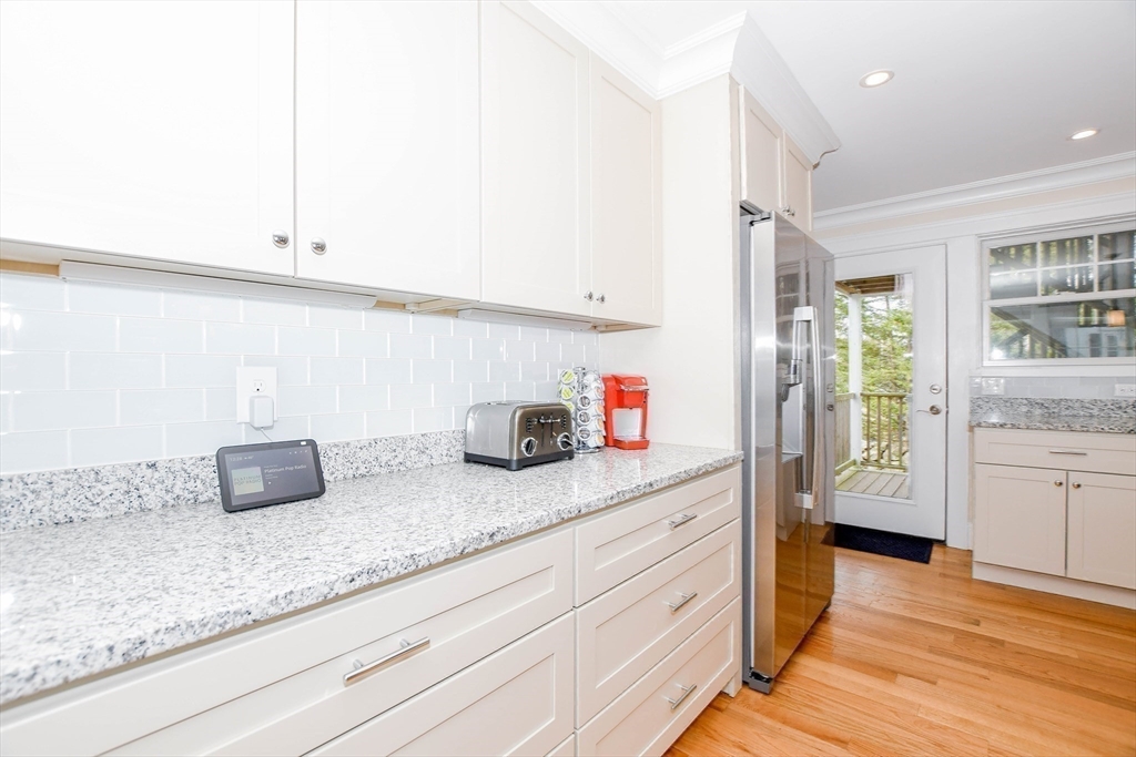 324 Front Street, Unit 2 Marion, MA 02738 - Photo 11 of 35 a kitchen with granite countertop white cabinets and white appliances