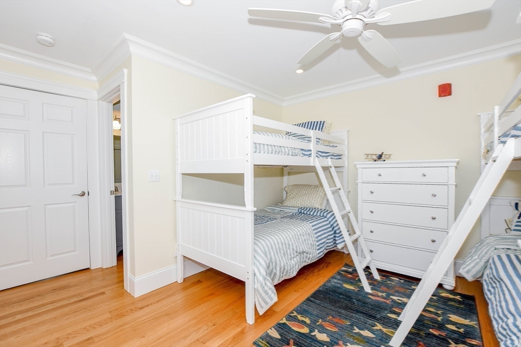 324 Front Street, Unit 2 Marion, MA 02738 - Photo 25 of 35 a bed room with a bed and a ceiling fan