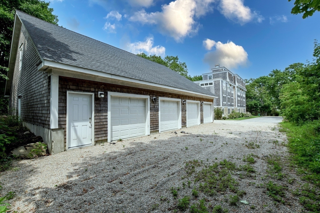 324 Front Street, Unit 2 Marion, MA 02738 - Photo 28 of 35 a front view of a house with a yard and garage