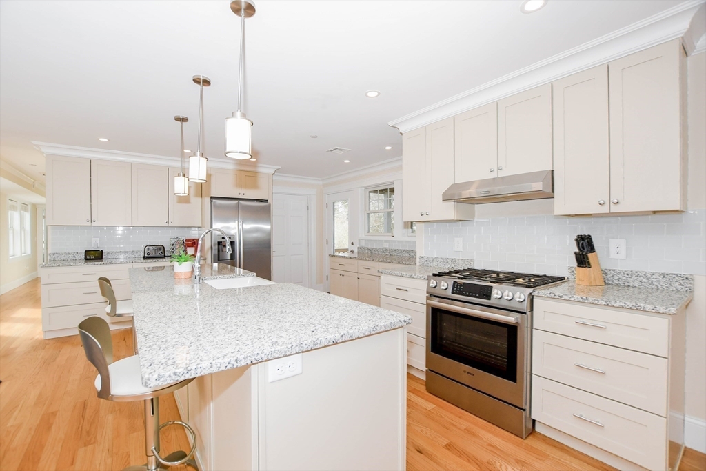 324 Front Street, Unit 2 Marion, MA 02738 - Photo 5 of 35 a kitchen with granite countertop a sink a stove and cabinets