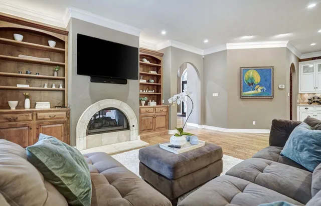 a living room with fireplace furniture and a flat screen tv