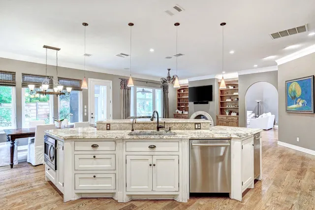 a kitchen with a sink stove and cabinets