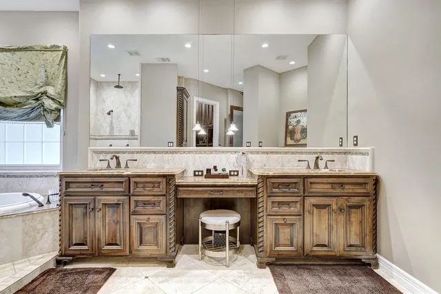 a spacious bathroom with a sink double vanity and a mirror