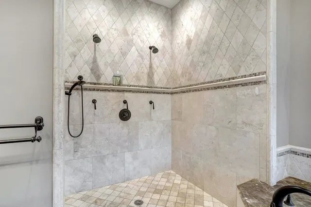 a bathroom with a granite countertop shower