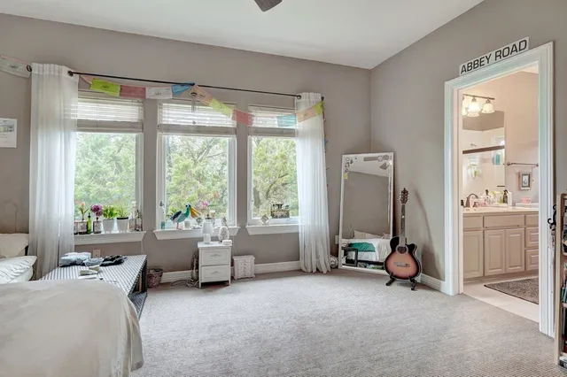 a room with a bed and a large window