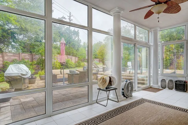 a bedroom with furniture and large windows