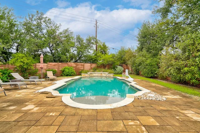 a view of a swimming pool with a yard