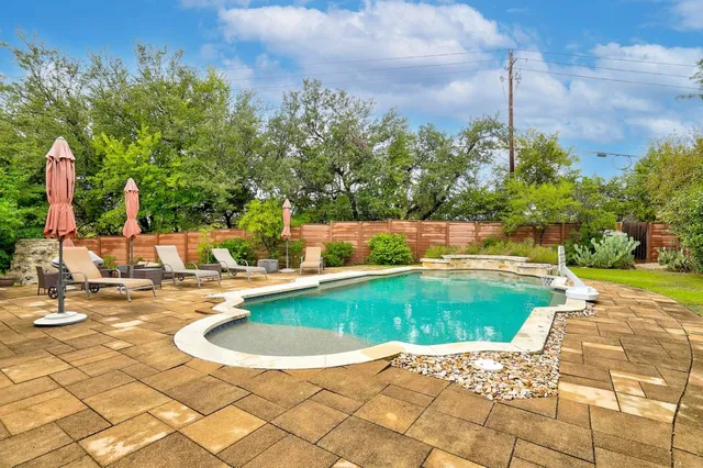 a view of a swimming pool with a yard
