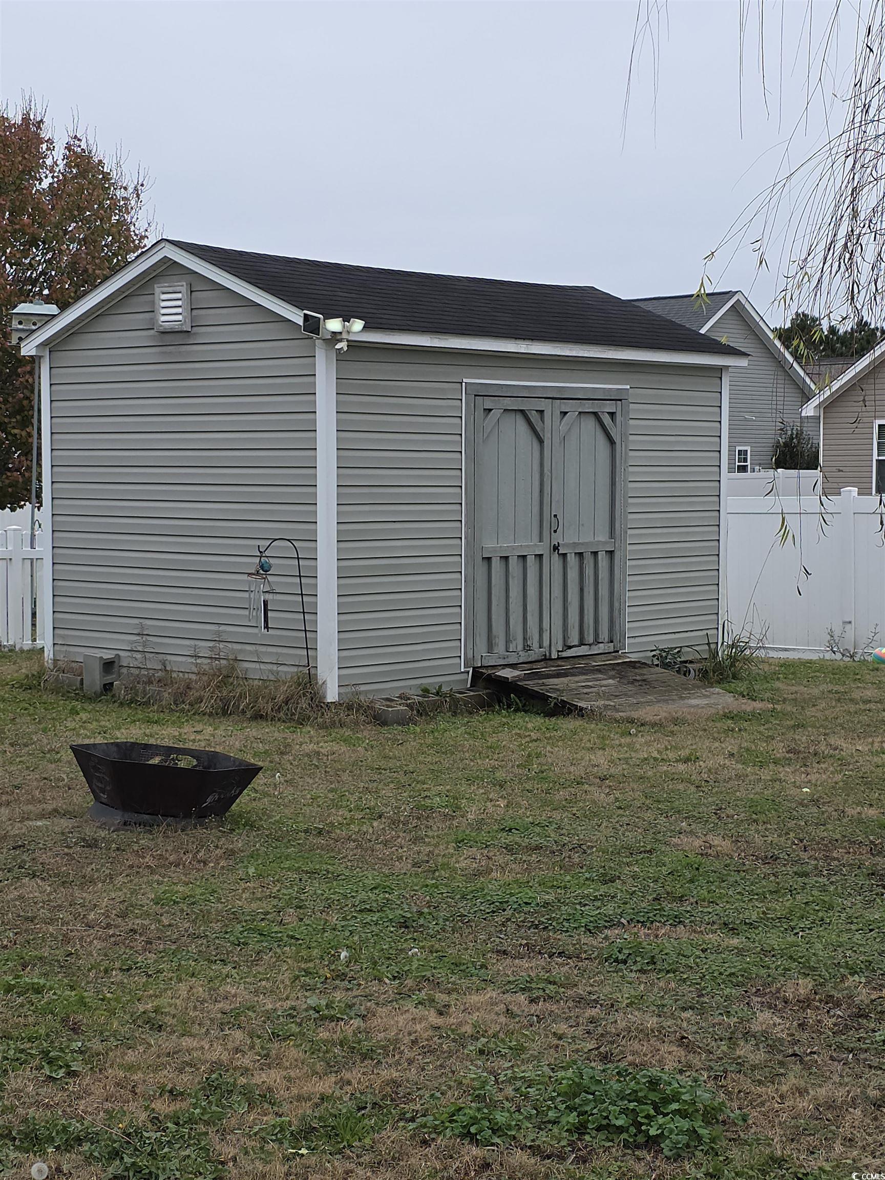417 Cassian Way Myrtle Beach, SC 29588 - Photo 4 of 13 View of shed featuring a fire pit