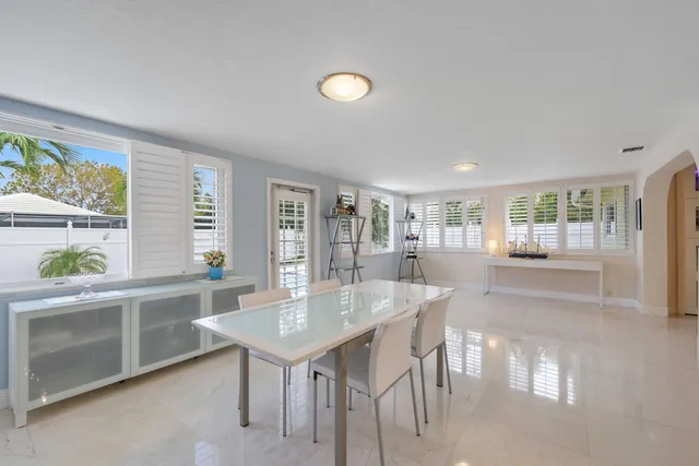 a view of a dining room with furniture and a potted plant