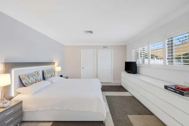 a large white bed in a white room
