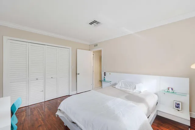 a bedroom with a bed and a dresser