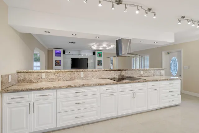 a bathroom with a granite countertop double vanity sink and a mirror