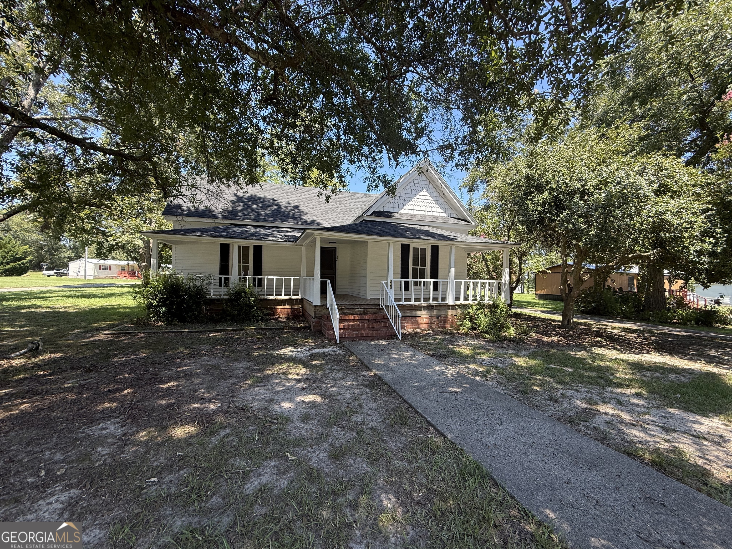 604 Shy Street Dexter, GA 31019 - Photo 12 of 36 a front view of a house with a garden