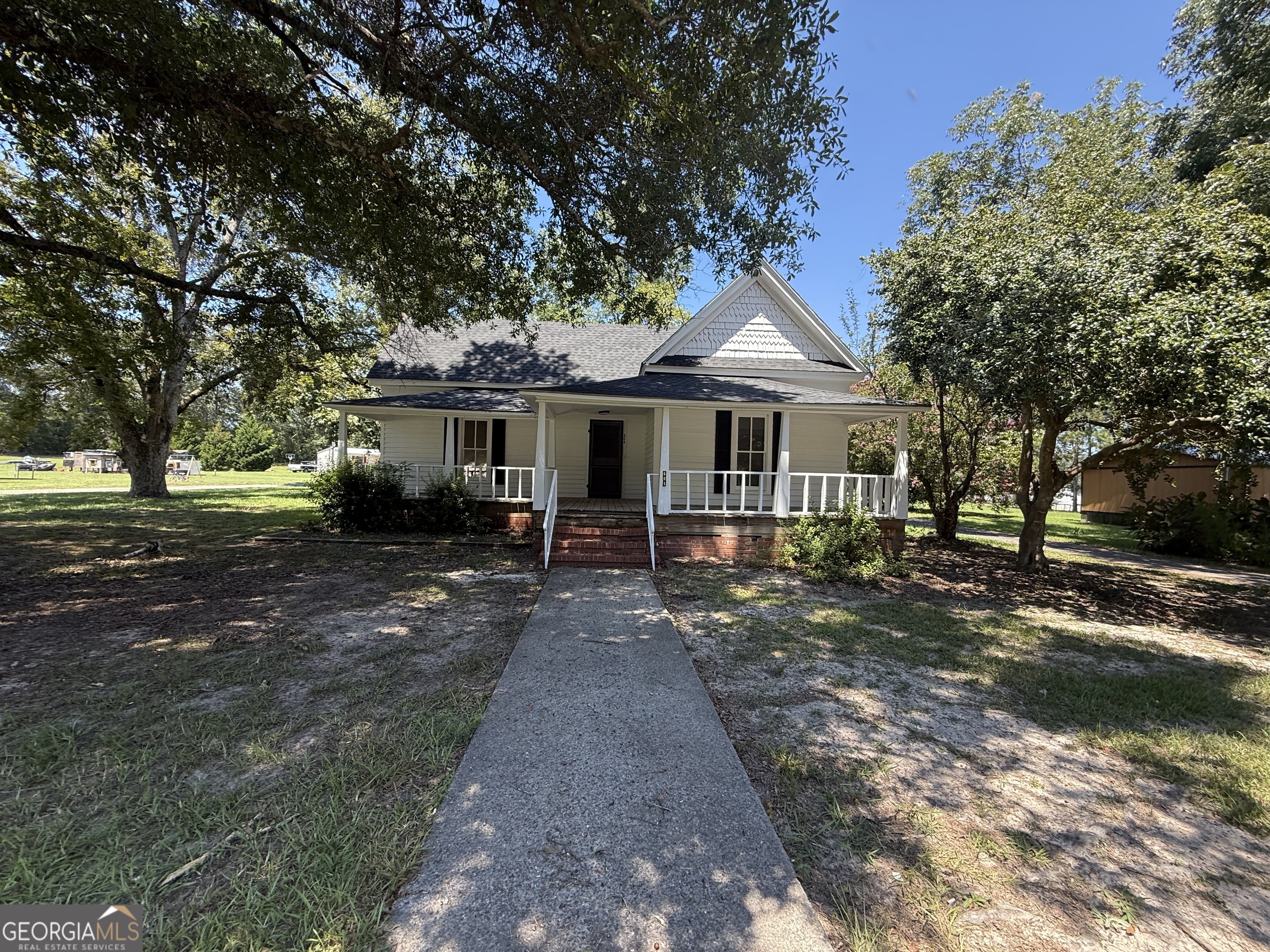 604 Shy Street Dexter, GA 31019 - Photo 13 of 36 a front view of a house with a garden