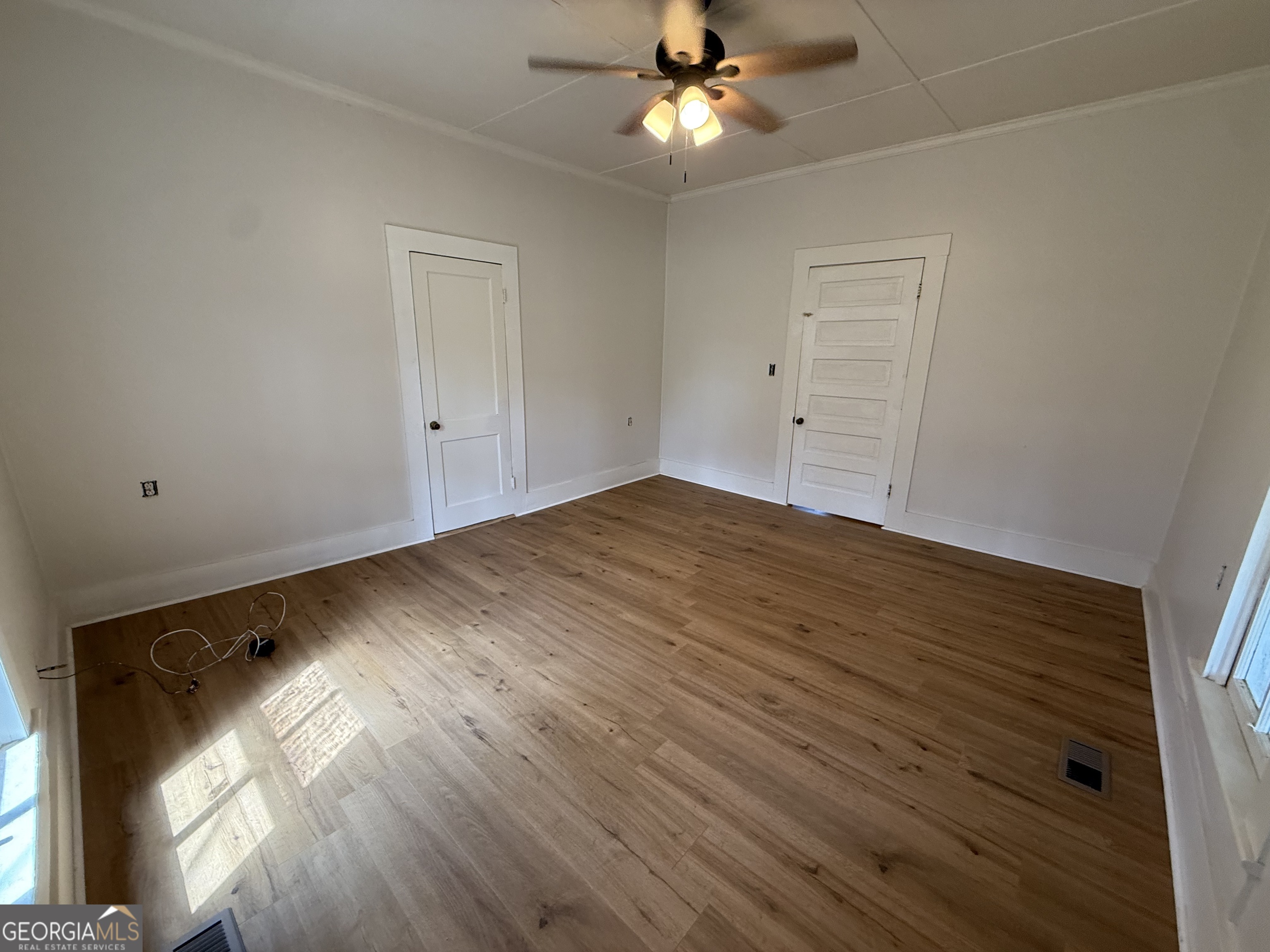 604 Shy Street Dexter, GA 31019 - Photo 18 of 36 a view of empty room with wooden floor and fan