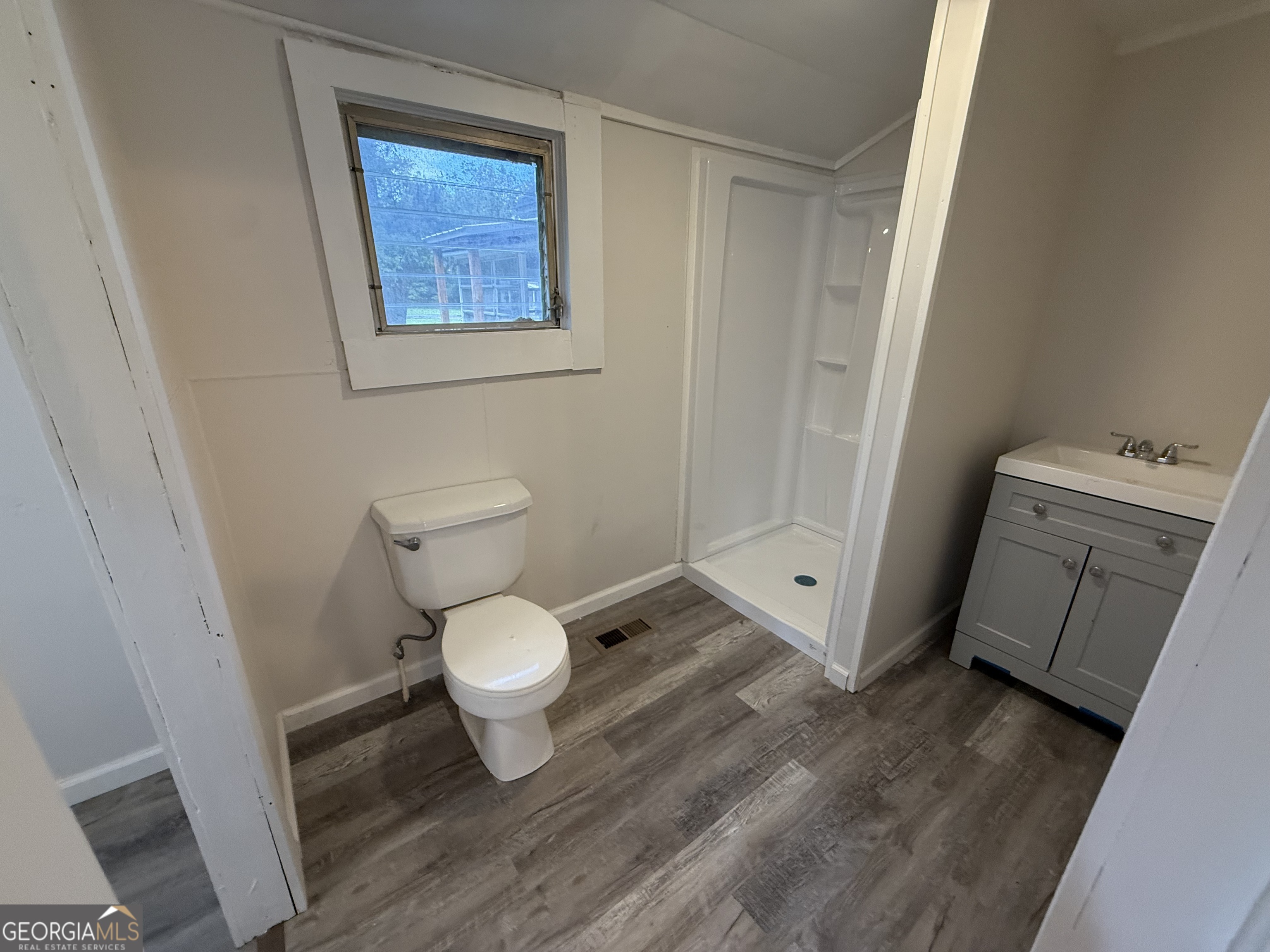 604 Shy Street Dexter, GA 31019 - Photo 19 of 36 a bathroom with a toilet and a sink