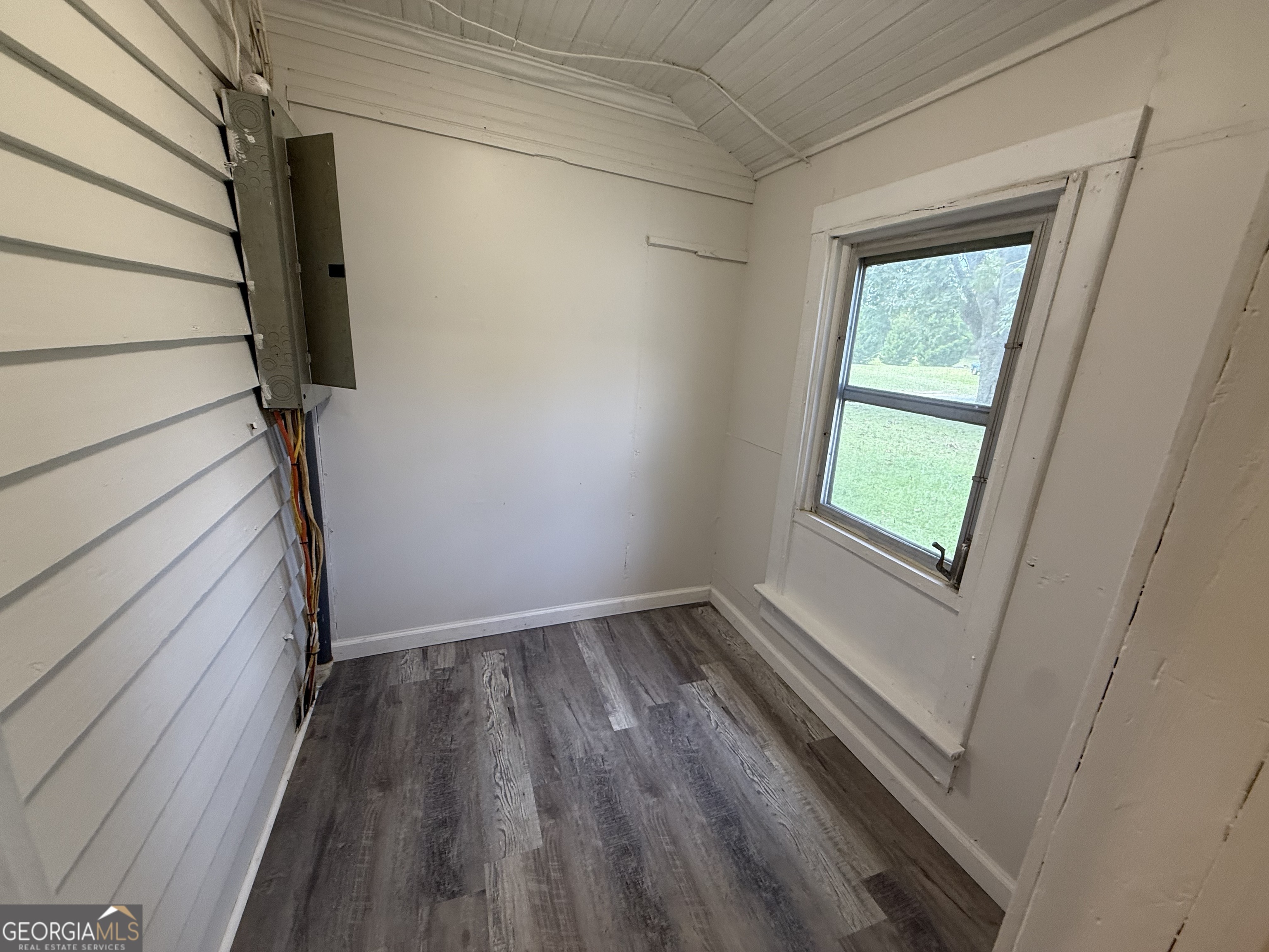 604 Shy Street Dexter, GA 31019 - Photo 20 of 36 a view of an empty room with wooden floor and a window