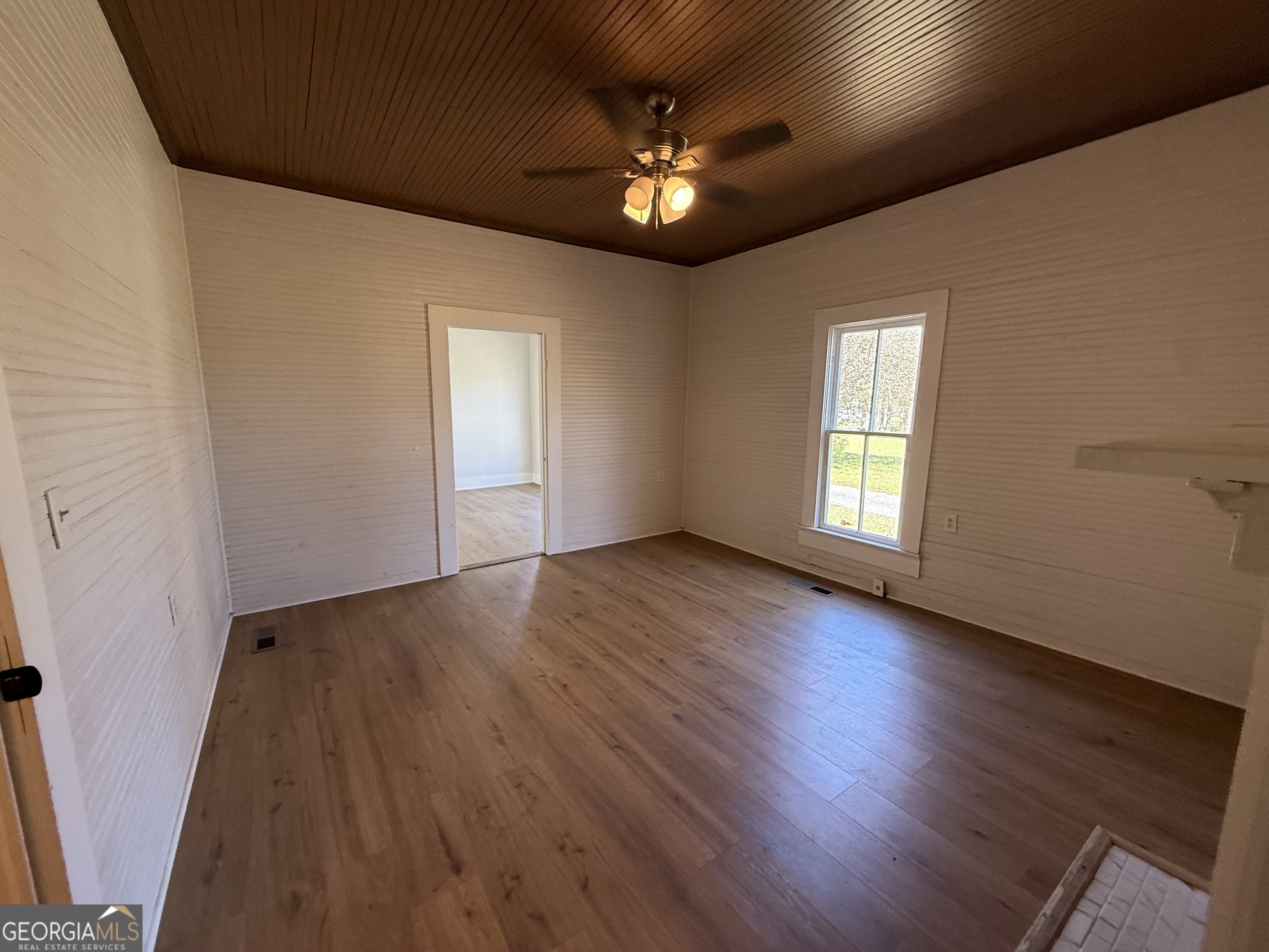 604 Shy Street Dexter, GA 31019 - Photo 26 of 36 a view of an empty room with a window and wooden floor