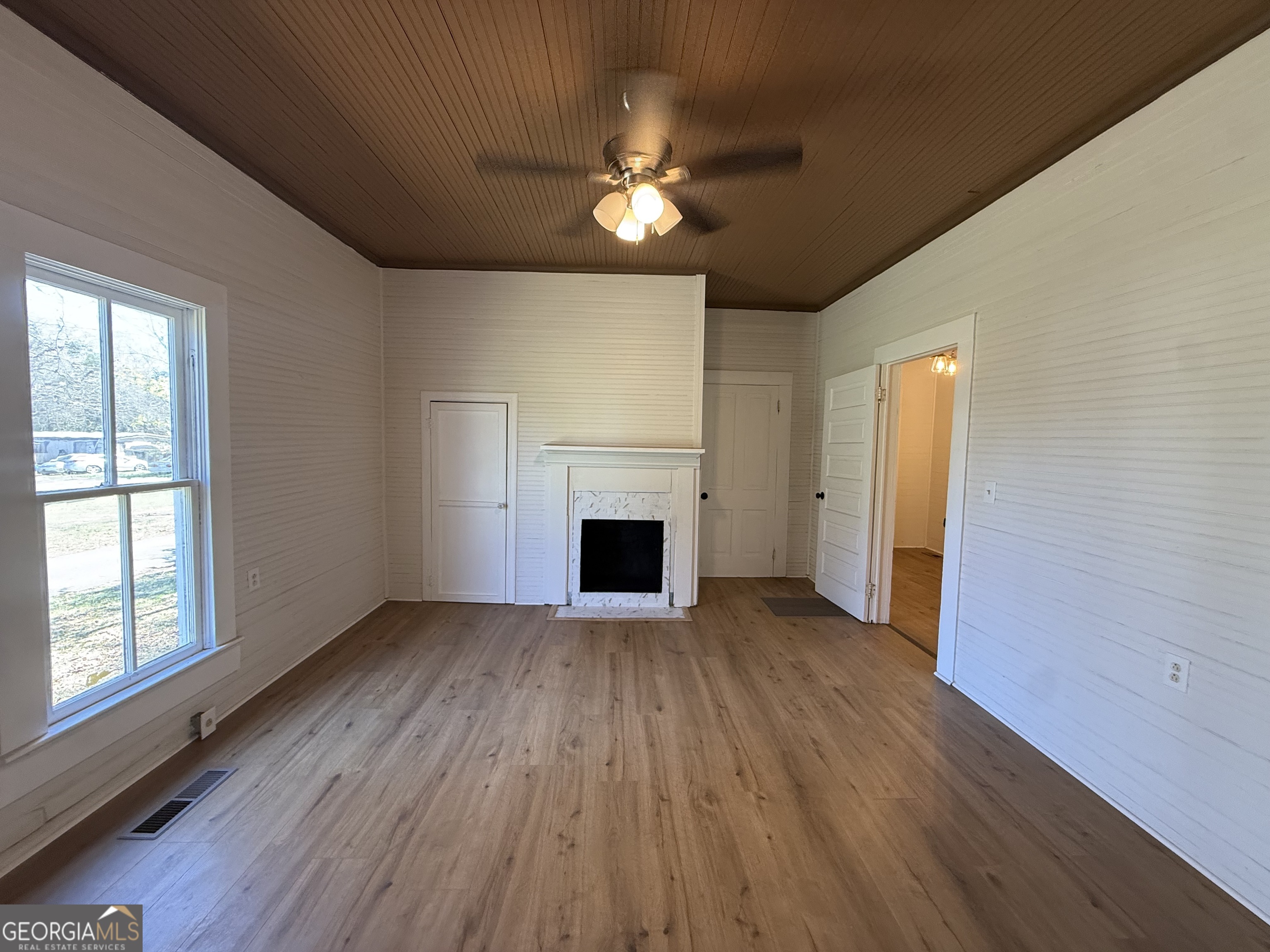 604 Shy Street Dexter, GA 31019 - Photo 28 of 36 a view of a livingroom with a fireplace wooden floor and window