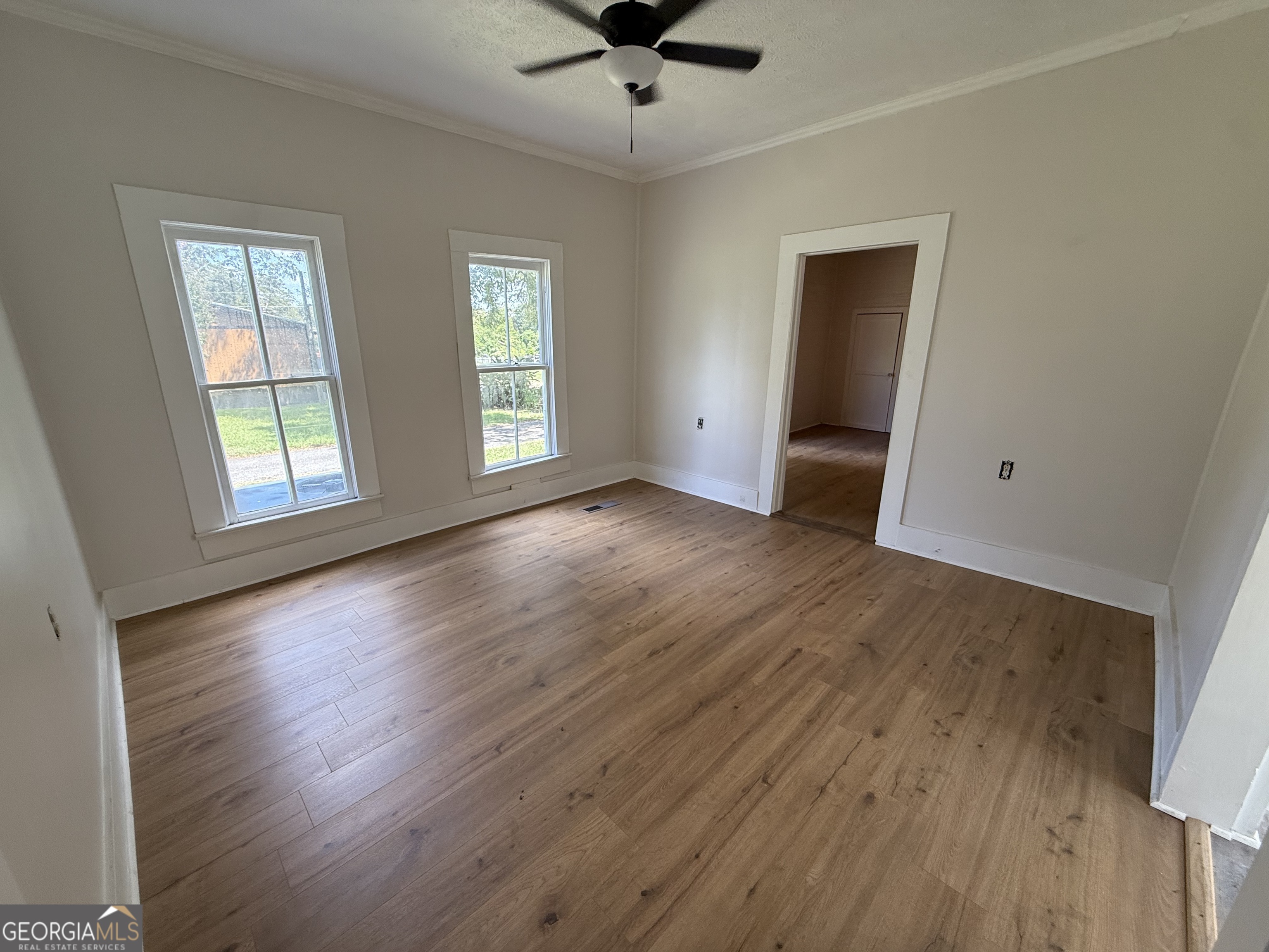 604 Shy Street Dexter, GA 31019 - Photo 30 of 36 an empty room with wooden floor and windows