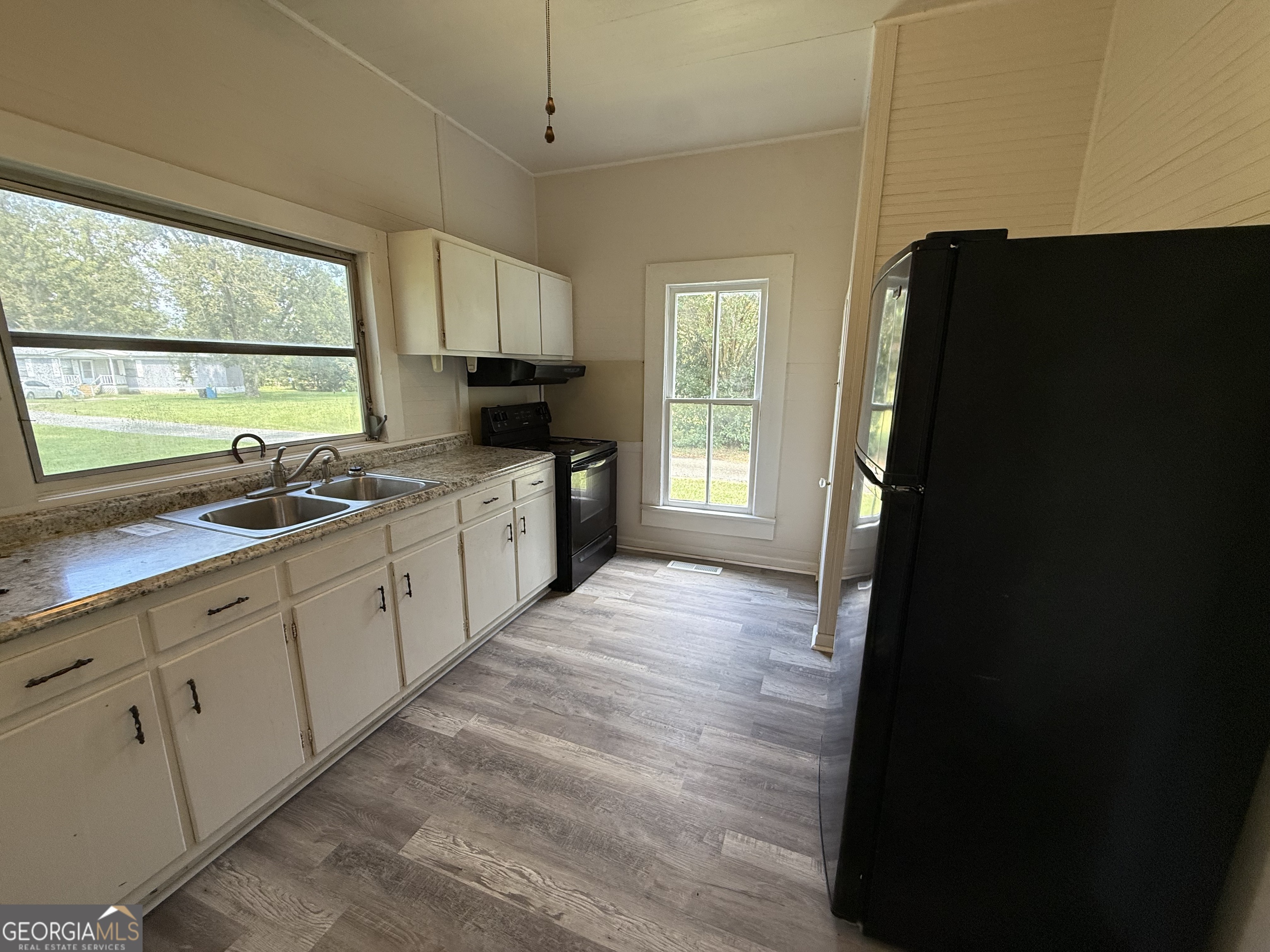 604 Shy Street Dexter, GA 31019 - Photo 32 of 36 a kitchen with a sink a window and stainless steel appliances