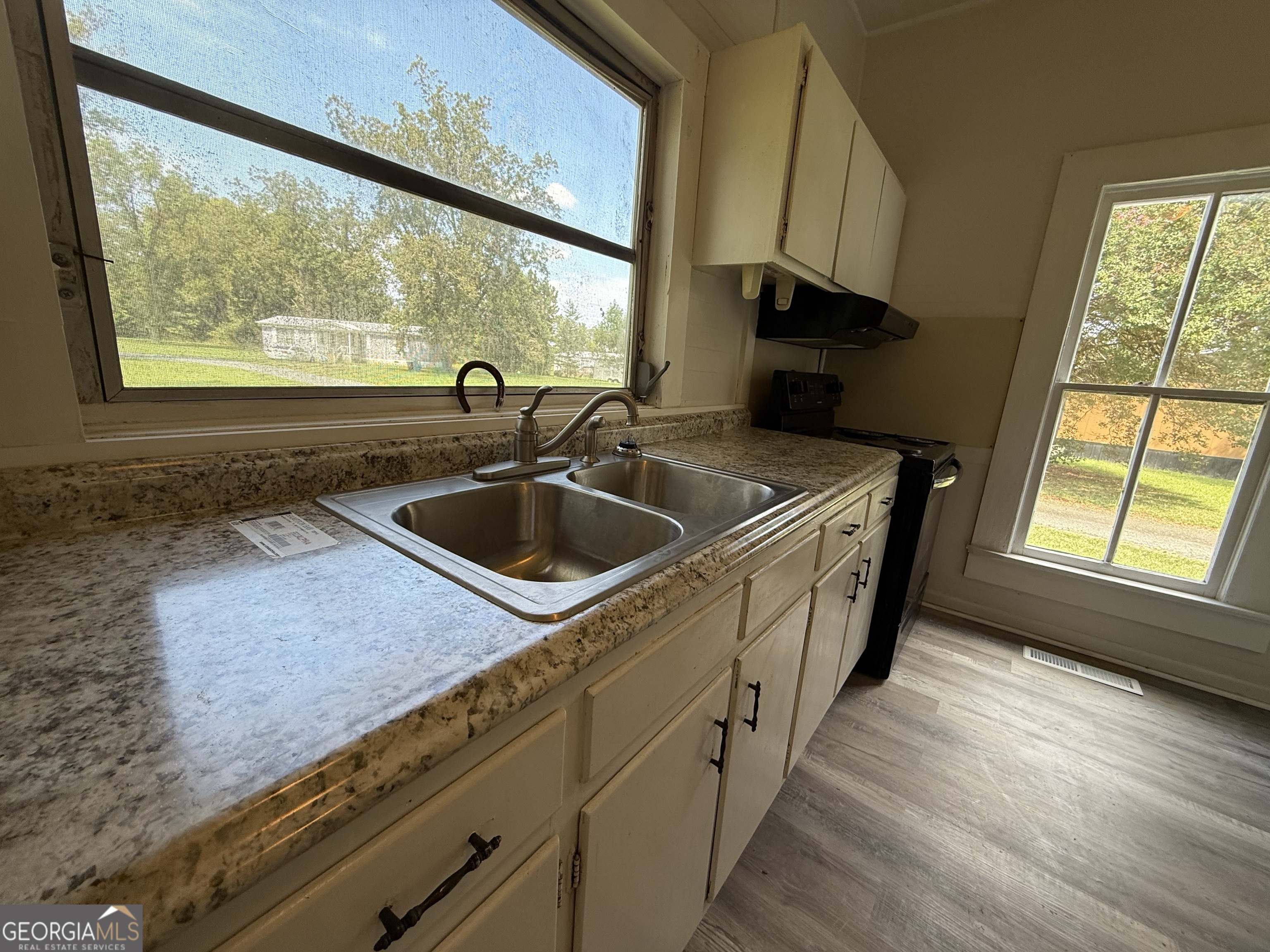604 Shy Street Dexter, GA 31019 - Photo 34 of 36 a kitchen with a sink and a large window